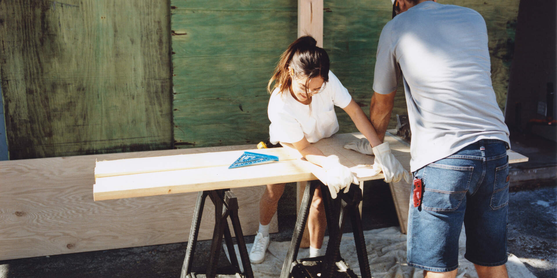 Man and woman wearing Dickies shorts working on work bench