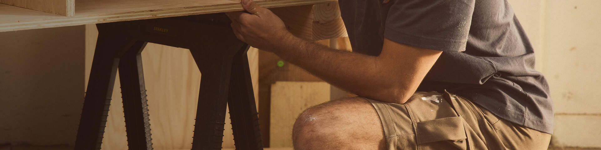 Man in cargo shorts working on tool bench