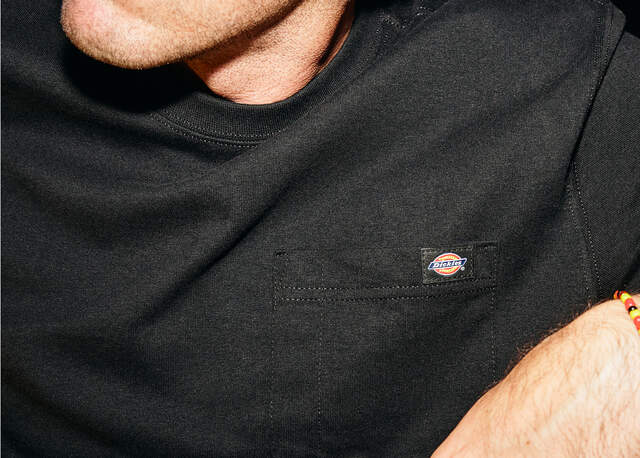 Close up of front pocket of dickies black tee shirt