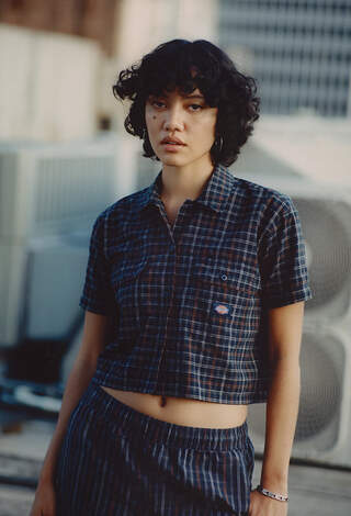Woman in Dickies pants and crop collared plaid top