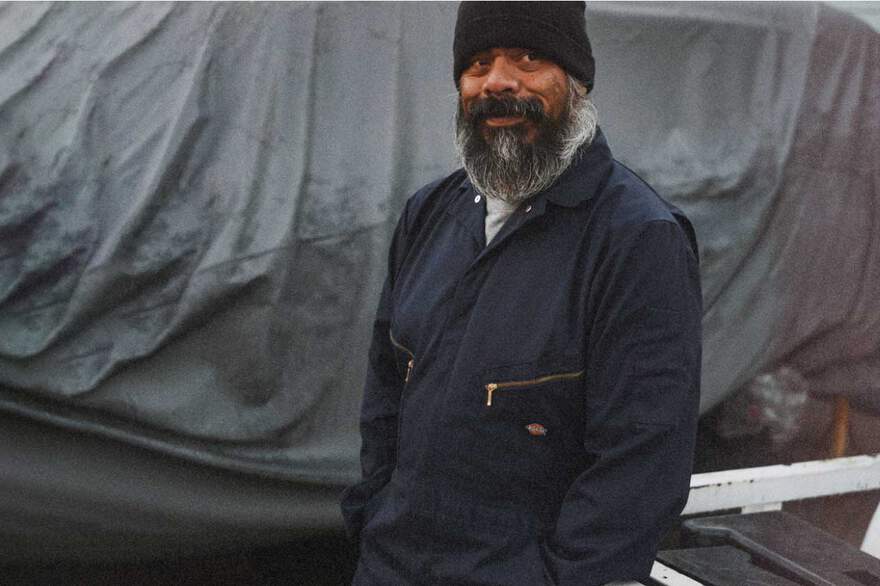 Man in a beanie wearing Dickies coveralls