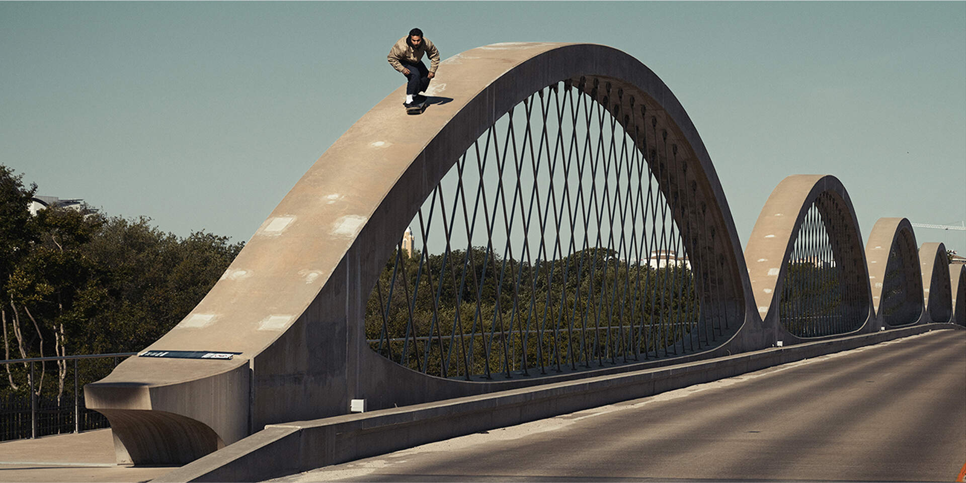 Skateboarder flying down a huge archway