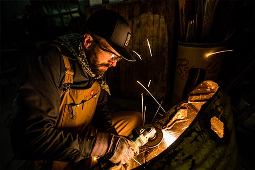 Disassembling metal and smoothing edges is a familiar task in Dolan’s studio.