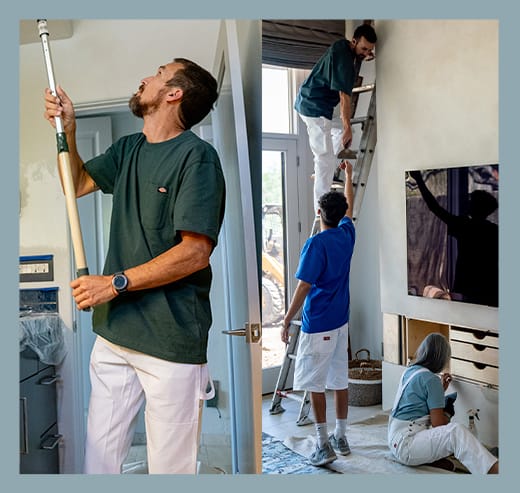 a man wearing agreen shirt rolling paint on a wall above his head, 2 men in another room while one is on a ladder, a woman sitting on the floor