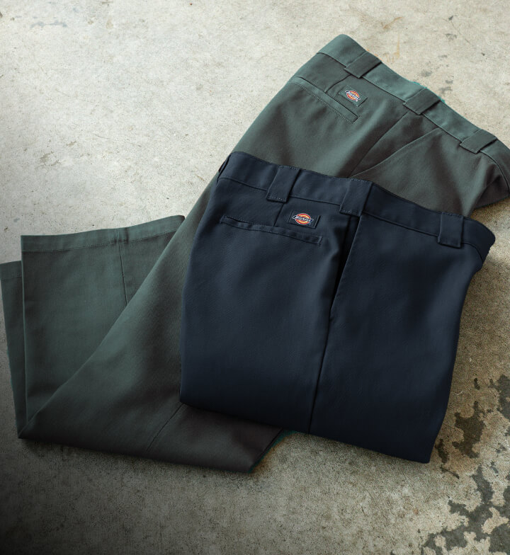 A laydown view of 2 874 mens work pants in dark blue and dark green