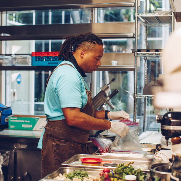 A food service worker prepping food.