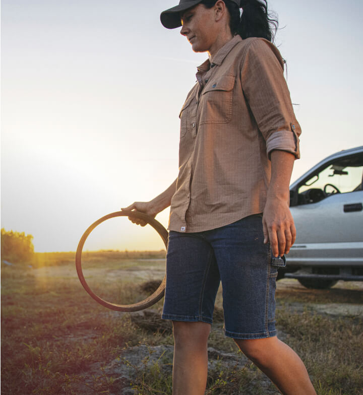 A woman wearing shorts walking outside.