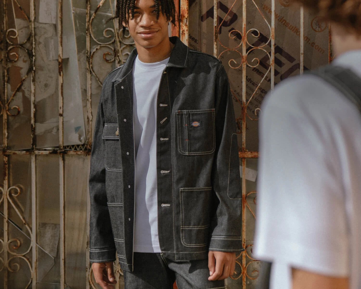 Two men dressed in dickies one hundred year denim looking at each other