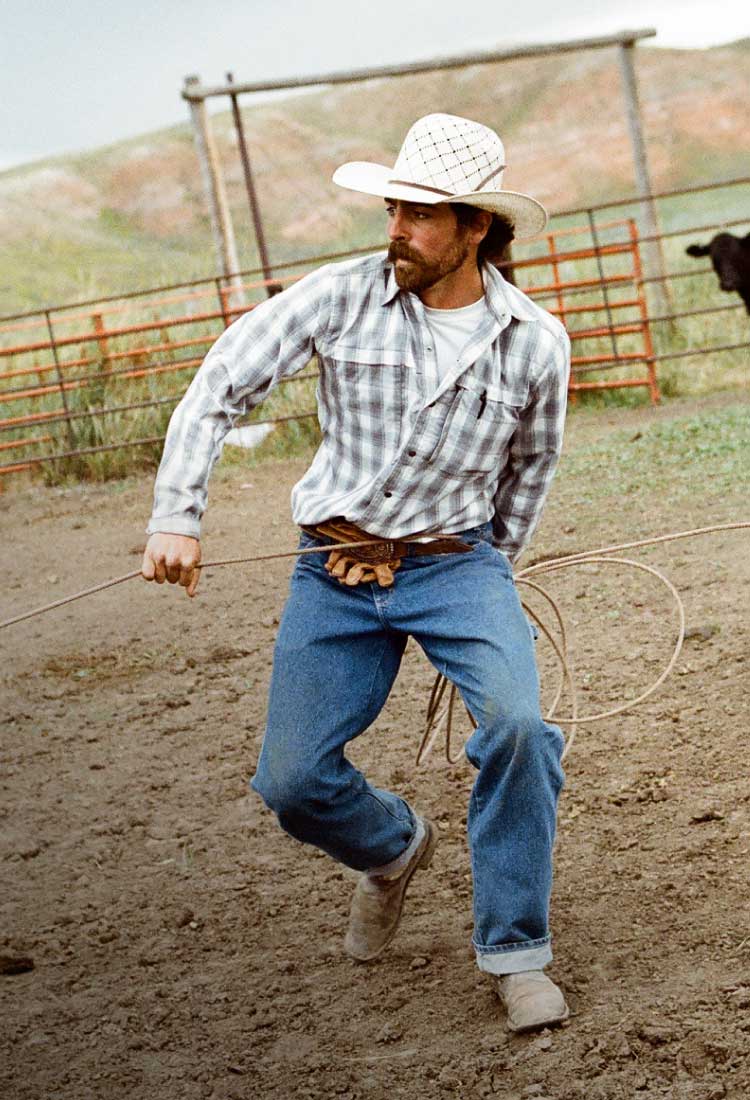 Cowboy roping steers in Dickies.