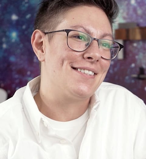 closeup of person wearing a white shirt and glasses