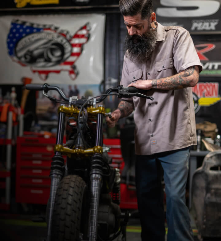 a mechanic fixing a two wheeled vehicle